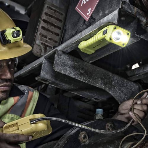 Portable Peli Rals lighting system used by a worker in a factory.